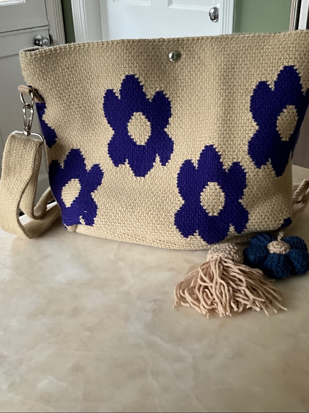Beige tote with purple flowers. Shoulder strap and optional short strap